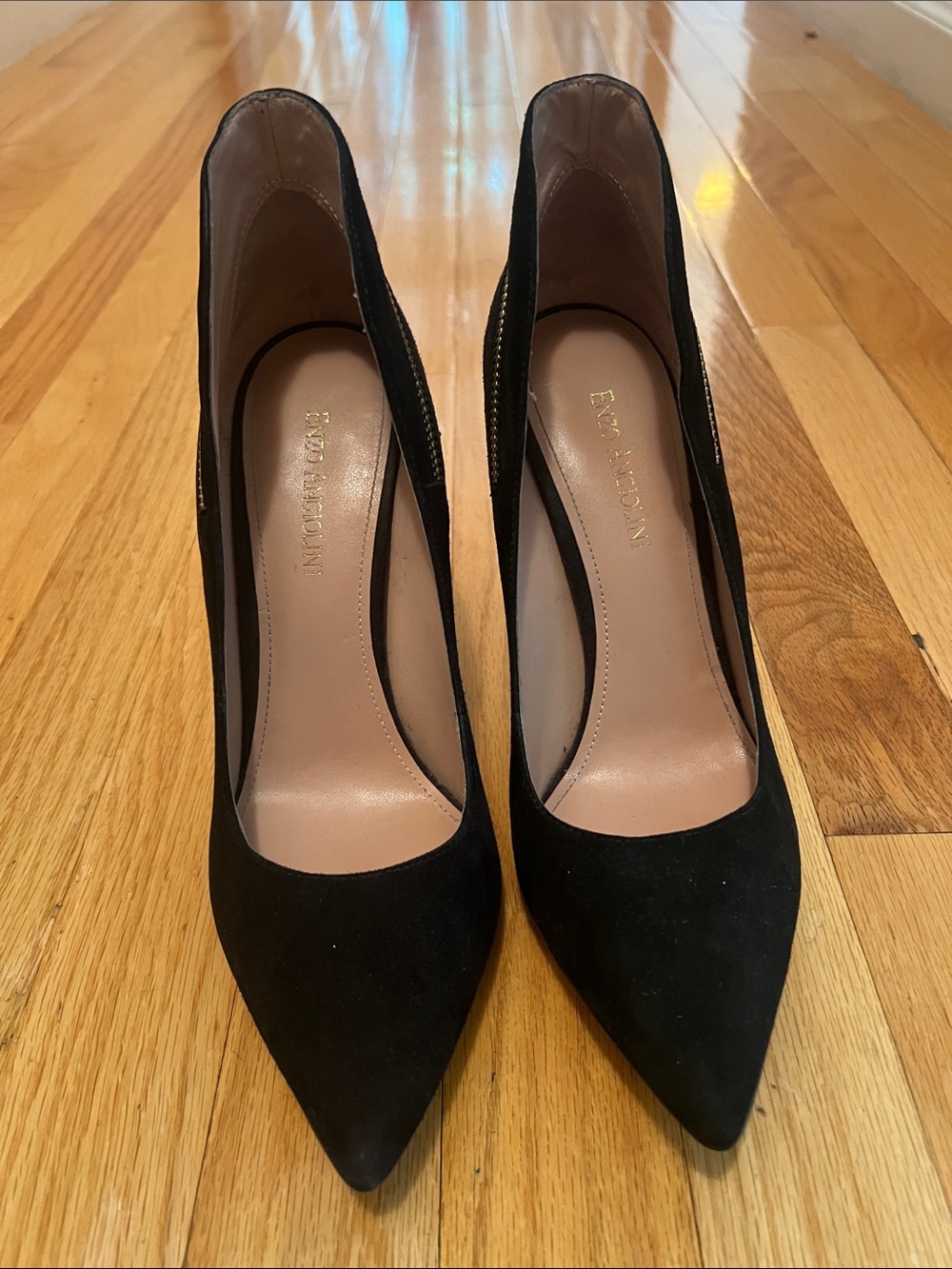 Enzo Angiolini black suede stiletto pumps with a side zipper detail.